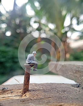 Conceptual Photo, Illustration for Dangerous and Critical Fate, Depression Sitting Man, at Corrosive Nail