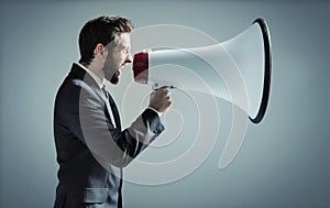 Conceptual photo of man yelling over the megaphone
