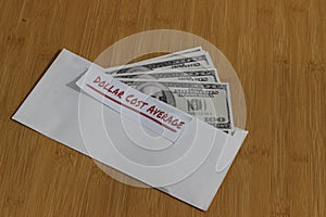 Conceptual Photo, money paper inside white Envelope and text Dollar Cost Average, or DCA golden rule investment