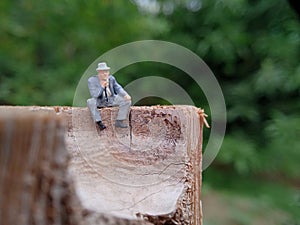 Conceptual Photo, Sad Sitting Man at Bamboo Pole in the park