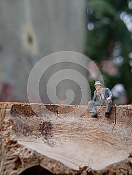 Conceptual Photo, Sad Sitting Man at Bamboo Pole in the park