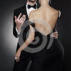 Conceptual photo of sexy elegant couple in the evening suit and dress