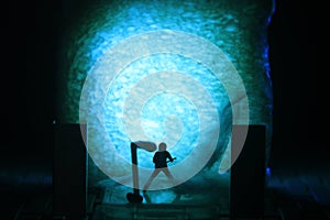 Conceptual Photo, Silhouette Bassist or Guitarist in Action, at Fake Stage, Blue Lighting