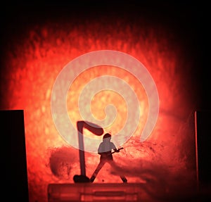 Conceptual Photo, Silhouette Bassist or Guitarist in Action, at Fake Stage, Red Lighting