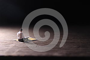 Conceptual Photo, Sitting Muslim, Islam People Reading Al Quran, at Wooden Floor