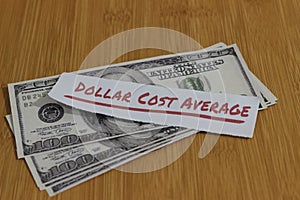 Conceptual Photo, Stack Randomly Money paperand text Dollar Cost Average, or DCA golden rule investment