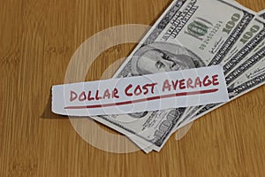 Conceptual Photo, Stack Randomly Money paperand text Dollar Cost Average, or DCA golden rule investment
