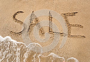 Conceptual photo of summer sale written on sandy beach