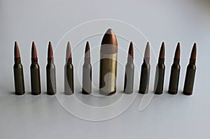 Conceptual photo on the theme of diversity with a large bullet in a row of identical smaller bullets