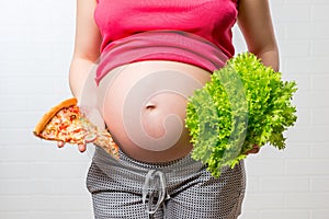 Conceptual photo - unhelpful and healthy food in the hands of a photo