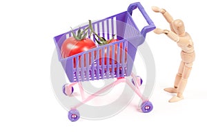 Conceptual photo with wooden man and shopping-cart