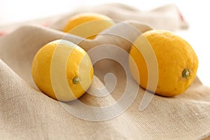 Conceptual photo. Yellow Lemons on the table. Summer day in Kitchen
