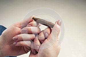 Conceptual photography against the war. A big bullet in the hands of a girl