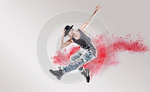 Conceptual picture of hip hop dancer among red dust