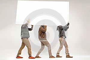 Conceptual picture of three guys carrying the board
