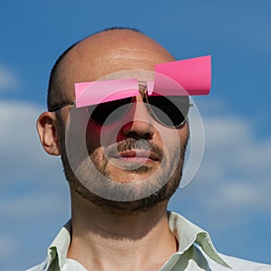 Conceptual portrait of a businessman in modern sunglasses pasted