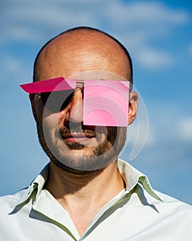 Conceptual portrait of a businessman in modern sunglasses pasted