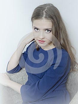 Conceptual portrait of a fashionable young, seductive, emotional, beautiful girl, woman with long flowing hair, in the interior