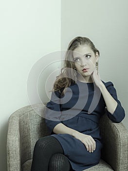 Conceptual portrait of a fashionable young, seductive, emotional, beautiful girl, a woman with long flowing hair, in the interior