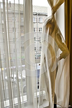 Conceptual portrait of a fashionable young, seductive, emotional, beautiful girl, a woman who wrapped herself in a curtain, tulle