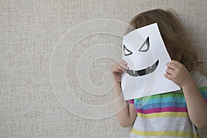 Conceptual portrait. Little child wearing a halloween mask