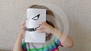 Conceptual portrait. Little child wearing a halloween mask