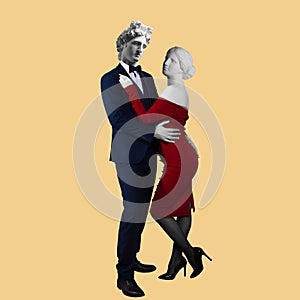 Conceptual portrait of a young couple Aphrodite and Apollo in elegant evening dress and suit.