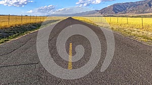 Conceptual remix of horizontal pan Highway along mountain under brilliant sky in Utah