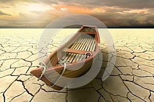 Conceptual representation of a drought with a boat on a dry lake