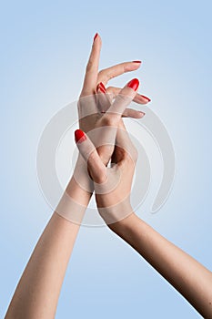 Conceptual shot of beautiful woman`s hand with manicure red nail polish