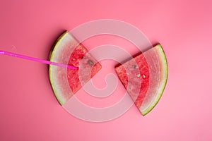 Conceptual shot with slices of ripe watermelon at pink background