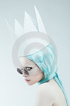 Conceptual studio portrait of woman with cyan hair