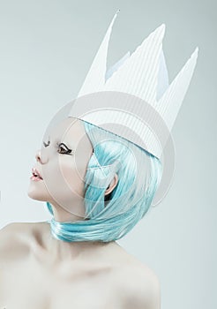 Conceptual studio portrait of woman with cyan hair