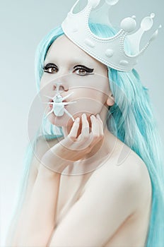 Conceptual studio portrait of woman with cyan hair