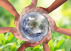 Conceptual symbol of multiracial human hands surrounding the Earth globe. Unity, world peace, humanity concept photo