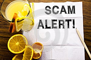 Conceptual text caption showing Scam Alert. Concept for Fraud Warning written on tissue paper on the wooden background with pen he