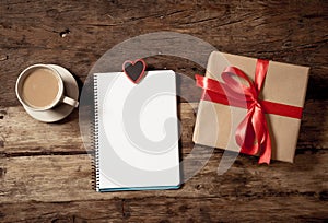 Conceptual Valentines image of note book with space for text, heart shaped chocolates and coffee