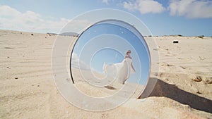 Conceptual video of fashionable woman in white maxi dress walking on the beach