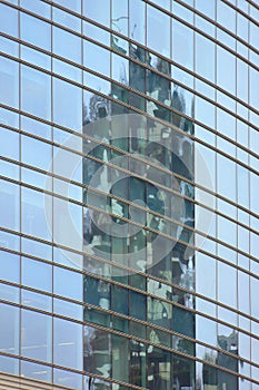 Conceptual view in the financial square of Milan: reflection of the vertical forest into Windows of Unicredit skycraper photo