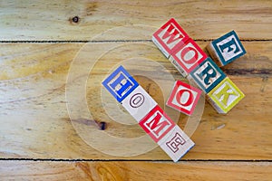 Conceptual of work from home during lockdown directives during virus outbreak. Wooden alphabet cubes forming WORKFROMHOME. Focus