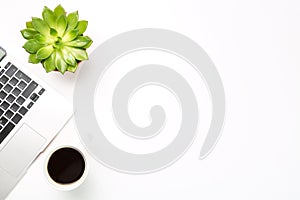 Conceptual workspace or business concept. Laptop computer with plant in a pot and cup of coffee on white background. Free space fo