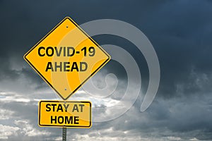 Conceptual yellow warning traffic sign about coronavirus epidemic photo
