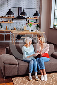 Concerned adult woman actively listening to grey-haired pensioner talking