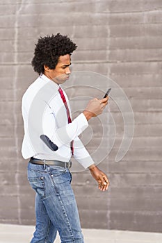 Concerned Black Businessman using his smartphone outdoors photo