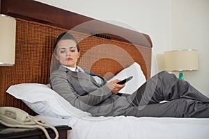 Concerned business woman laying on bed