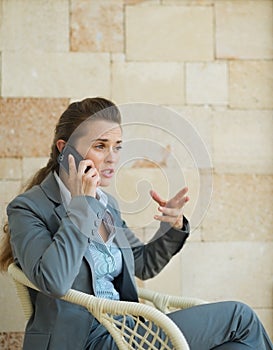 Concerned business woman speaking mobile phone