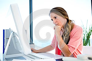 concerned businessWoman staring worriedly at a computer