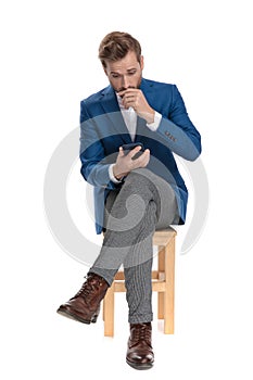 Concerned casual man looking to his phone