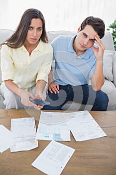 Concerned couple doing their accounts