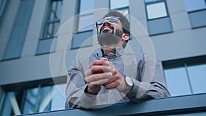 Concerned disappointed Arabian Indian businessman upset business man dismissed office worker on terrace outdoors worry